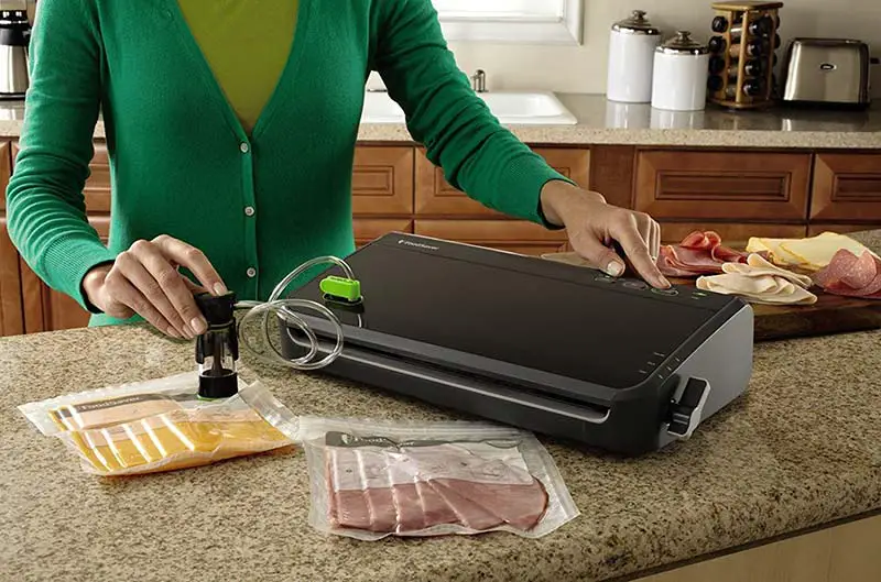 A women sealing food with the Best Food vacuum sealer machine