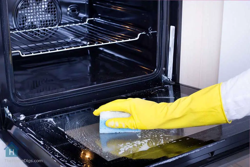cleaning the oven with non toxic oven cleaner and foam scrubber