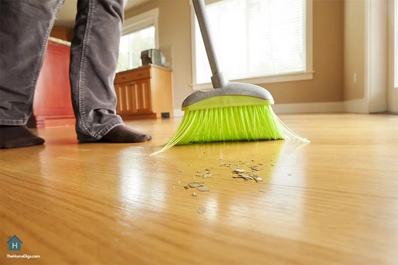 sweeping hardwood floors with soft bristle broom