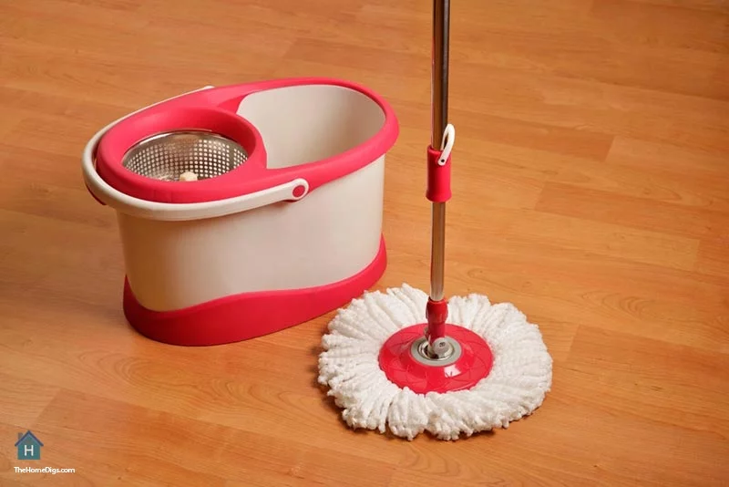 sweeping hardwood floors with cleaning-mop