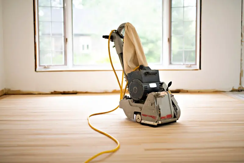 Sanding-hardwood-floor-with-a-drum-sander