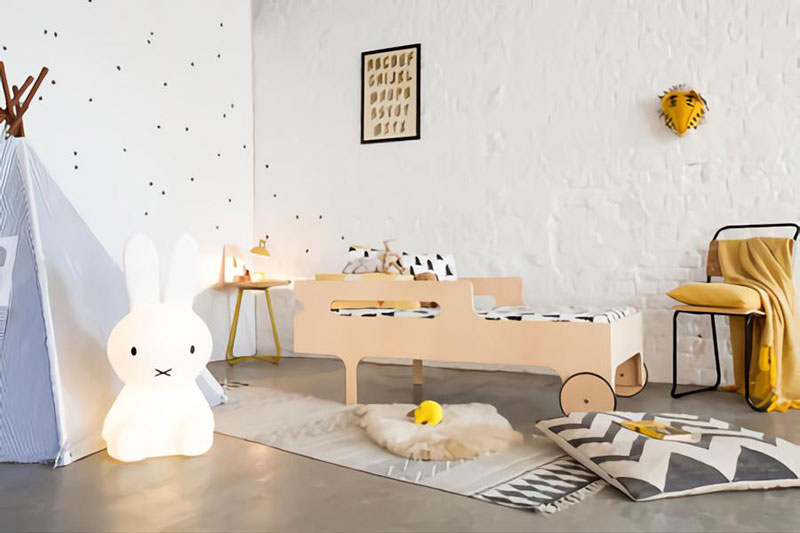 A-child's-bed-in-a-white-bedroom-with-poured-concrete-floor